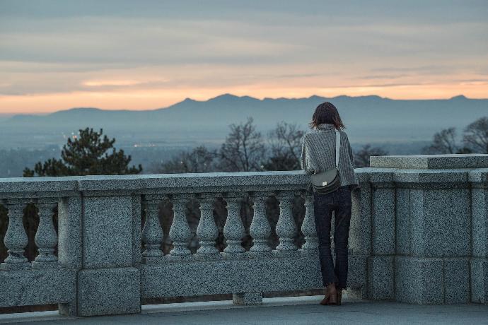 woman leaning on concrete rails